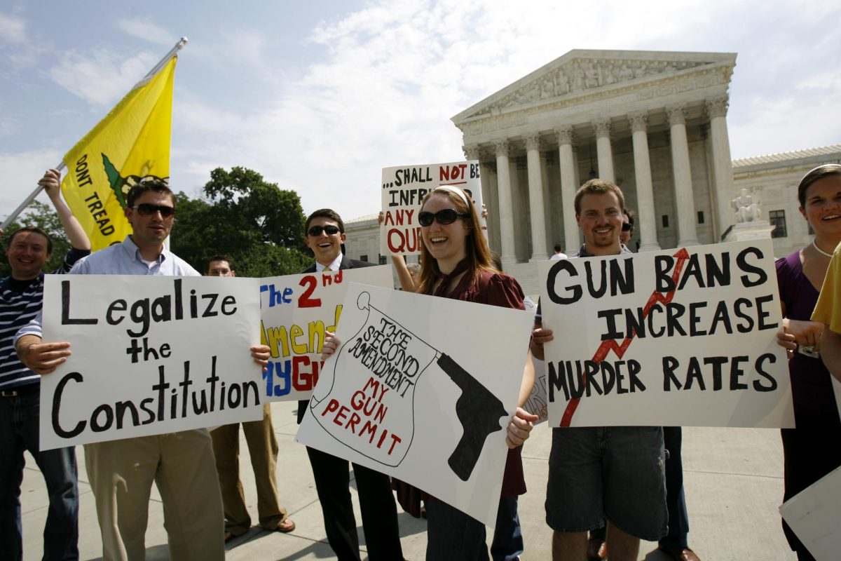 Pro gun-right supporters hold up signs outside the supreme court in 2008 after it's ruled that keeping guns in your home for self defense is an American right.