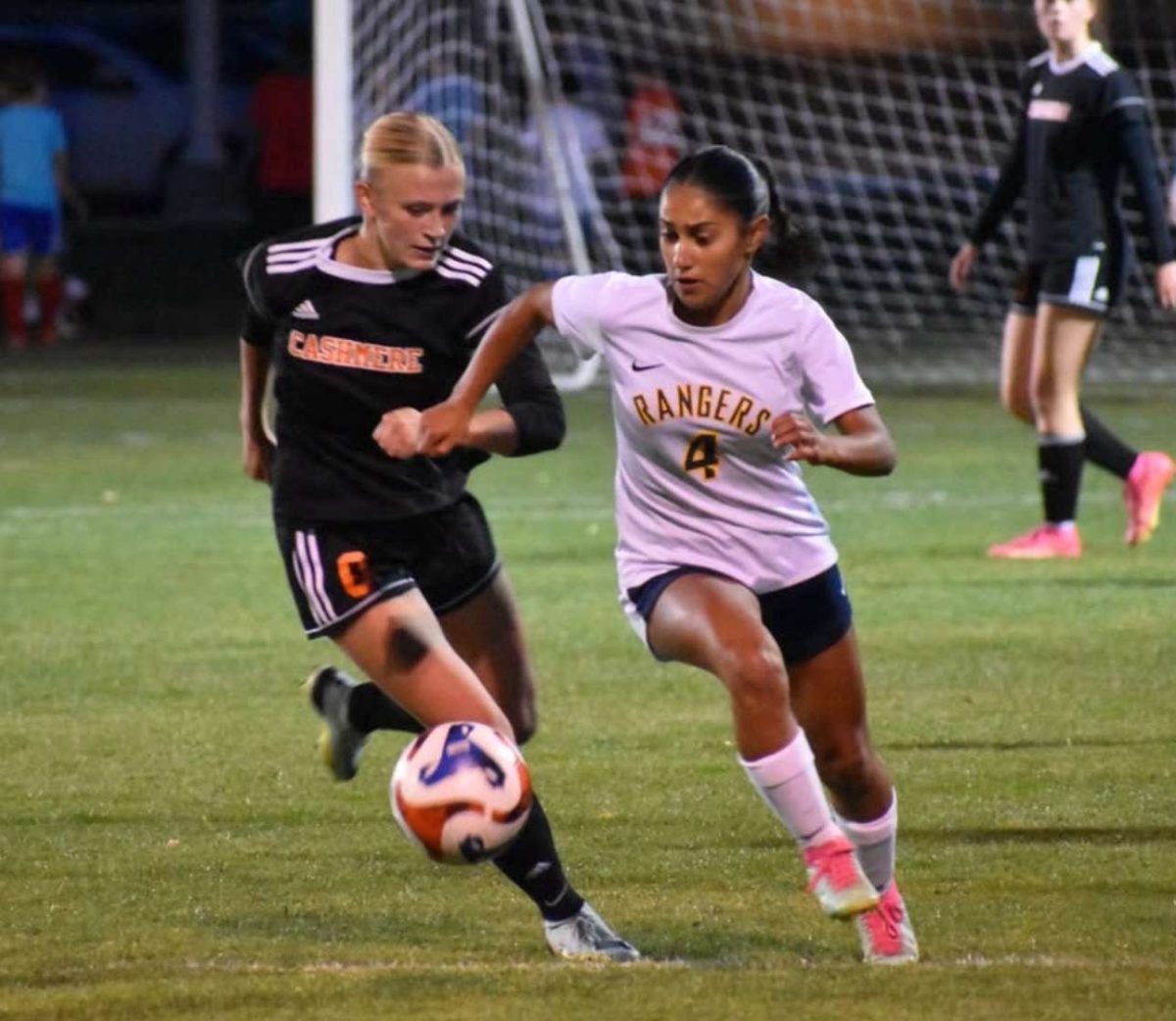 Senior Defender Quinn Pace runs along side opponent as she attempts to steal the ball from opposing player.