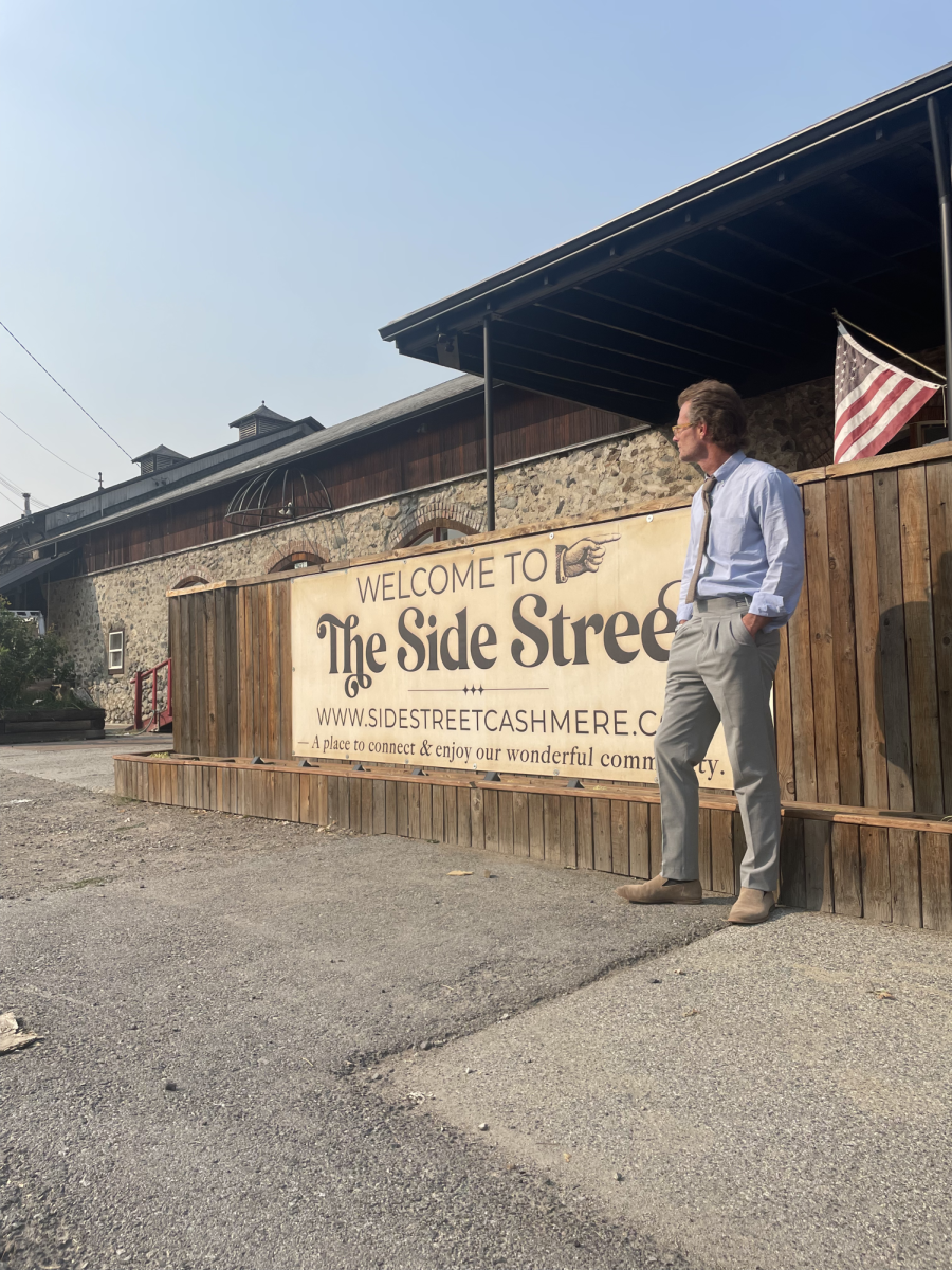 Andrew Thomas, owner of Sidestreet, stands outside as he admires Cashmere and it's charm. 