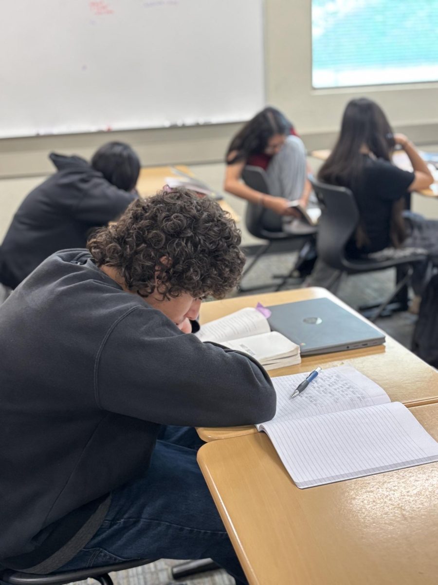 Freshman student Aurelio Ruiz reads in his freshman English class on the second week of his first year of high school. 