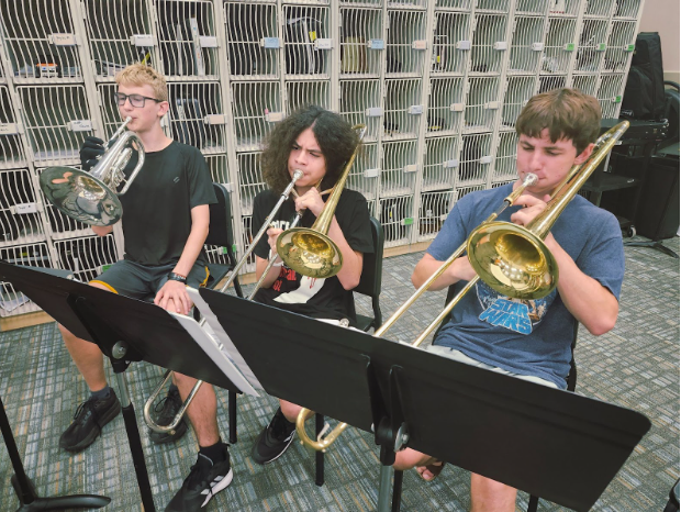 Band members (Pictured left to right in order) Judah Lewis, Angel Moreno, and Oliver Chalmers practice “Louie Louie” for an upcoming football game. 
