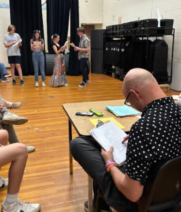 New director Brady Dundas follows along on his script of “A Midsummer Night’s Dream” as actors audition. To his right, unpictured, Assistant director Wendy Tankersley and Susan Gubsch help him with his new responsibilities and hard choices.