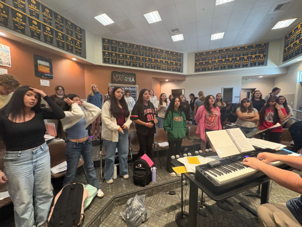 Mr. Ream playing piano leading concert choir in warm-ups.