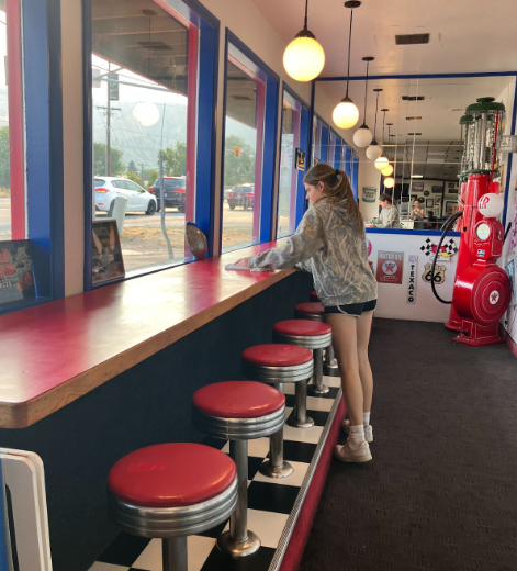 Olivia Smith cleaning tables at Hot Rod cafe where she works year round.