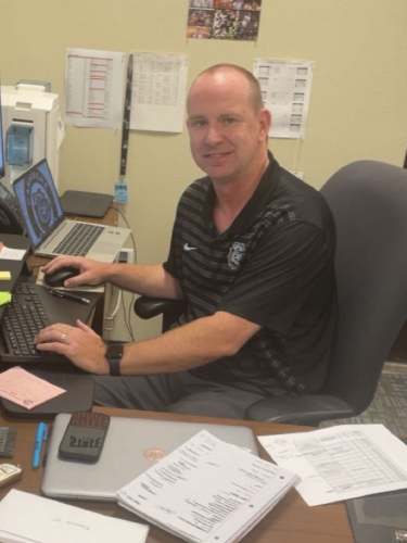 Cashmere athletic director sits at his desk.