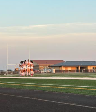 Cashmere Bulldogs Varsity join in a huddle at halftime during an intense game.