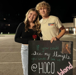 Trip Martin and Lexi Lutton stand side-by-side in the high school parking lot after homecoming proposal Monday night.
