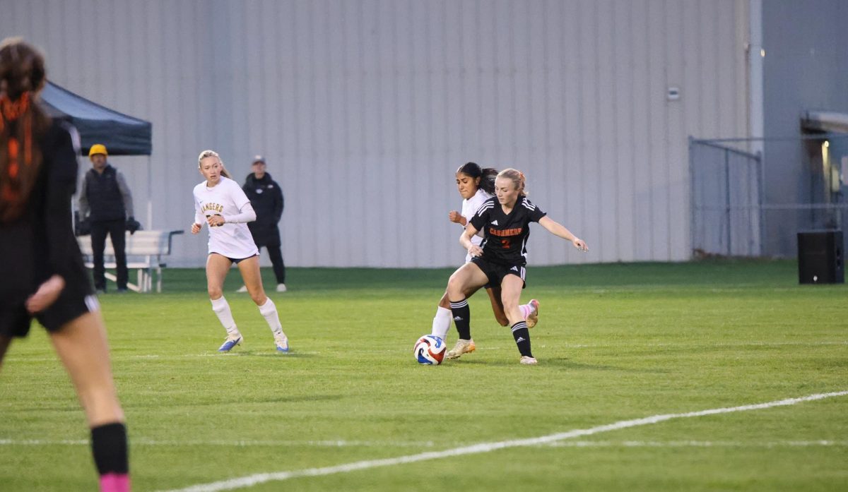 Junior forward Brynne Patrick dribbles the ball past Naches defender