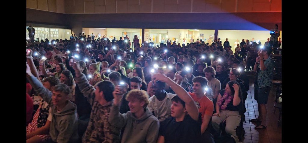 CHS Students raising their flashlights while Gracie Rengelli sings.
