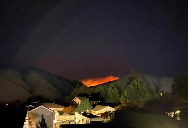 The Sugarloaf fire as seen from Wohlers Road in Cashmere, the red glow lighting up the sky as smoke billows up from the flames. 