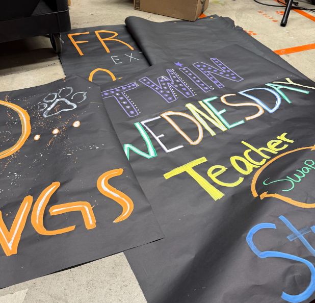 Dress-up day posters are being prepared to be hung up.