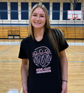 Hazel Schade poses on the volleyball court, showing off her side-out ambassador pride. 
