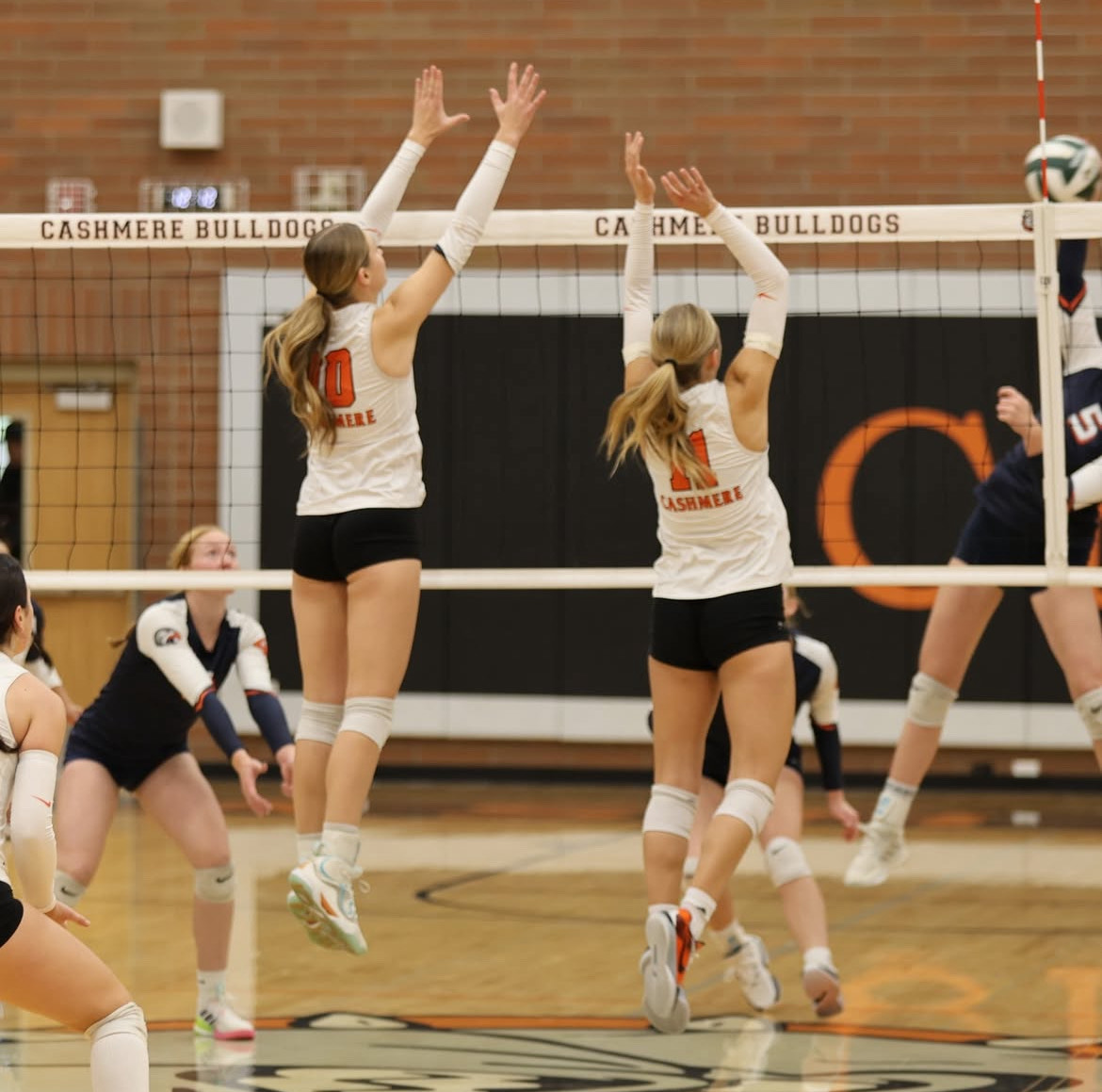 Senior Hazel Schade and Junior Taylor Kunz block the ball as the Bulldogs ride into the state tournament.