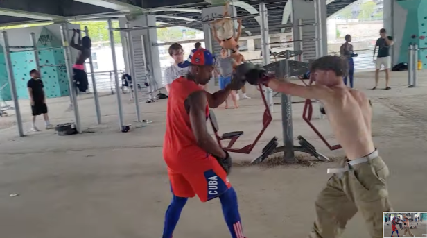 Asher Peyton, hitting mitts in Paris, held by Cuban Olympic Boxer Luis Ortiz.