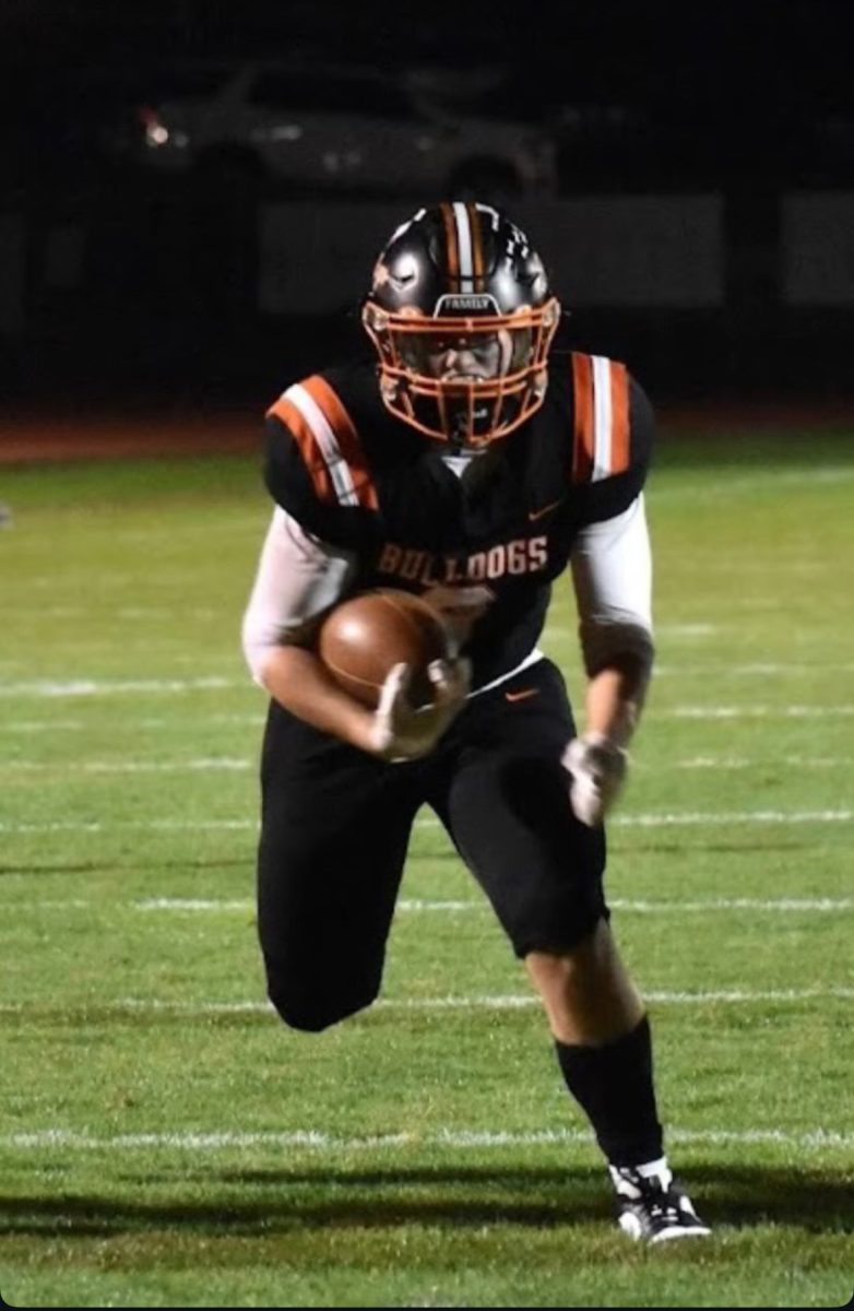 Senior tailback Thomas Bergran runs up the middle as he concludes his career in the orange and black.
