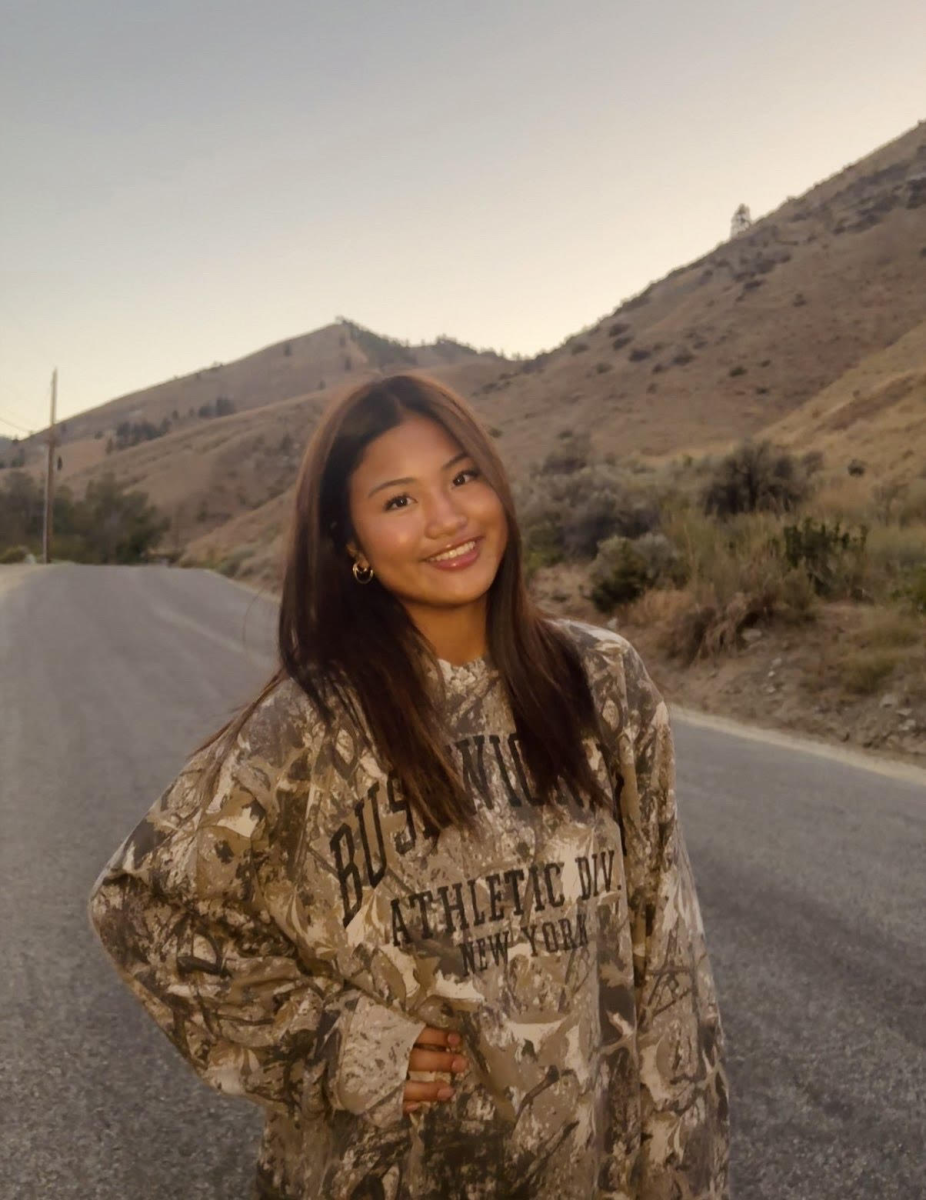Mandy Barba smiling in the light of the setting sun.