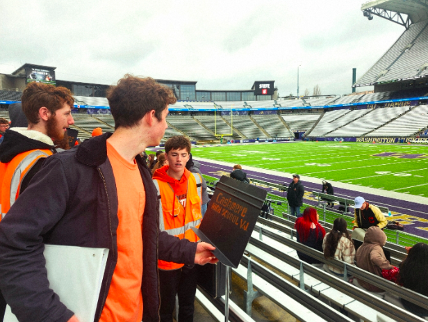 Arrival at the End: the CHS pep band setting up above the football field.

It was a sublime experience for the band when they walked out into Husky Stadium, the largest live venue in the state. The mass of Cashmere fans, almost all in orange and black, cheering on the team, warming up on the field, set an incredible tone, especially considering that this was the end of the line for the Bulldogs. While the setup was a little difficult, with constant re-adjustments of instrument sections courtesy of Mrs. Chalmers, when all was said and done, the band was locked and loaded to provide sonic glory to the team and their fans.


