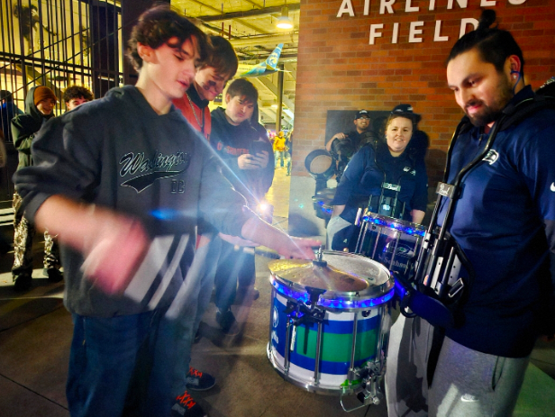  A Battle for the Eons: Ashur Yearous showing off his snare and high-hat playing prowess.

After the tragic 20-21 ending of the game, Cashmere fans were universally bummed-out, and the pep band wasn’t exempt. But spirits were raised after the band saw the Seattle Seahawks drumline, perhaps in an effort to cheer up the sad Cashmereians, playing some tight cadences at the stadium exit. And then the unthinkable happened: Ashur Yearous, a Sophomore CHS percussionist, challenged a member of the drumline to a snare drum duel, which the member accepted. The following 2 minutes saw a battle for all time. Monstrous snare rolls and rimshots were wrapped out, and both musicians gave it their all. A video of the duel was posted on the SCAC Barstool Instagram page, accompanied by a poll asking who did it better. Yearous won 79% to 21%.
